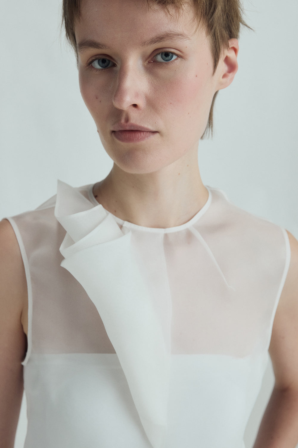 VICKTEERUT Sleeveless Blouse with Sculptural Rolled Fabric Detail เสื้อแขนกุด ตกแต่งผ้าม้วน