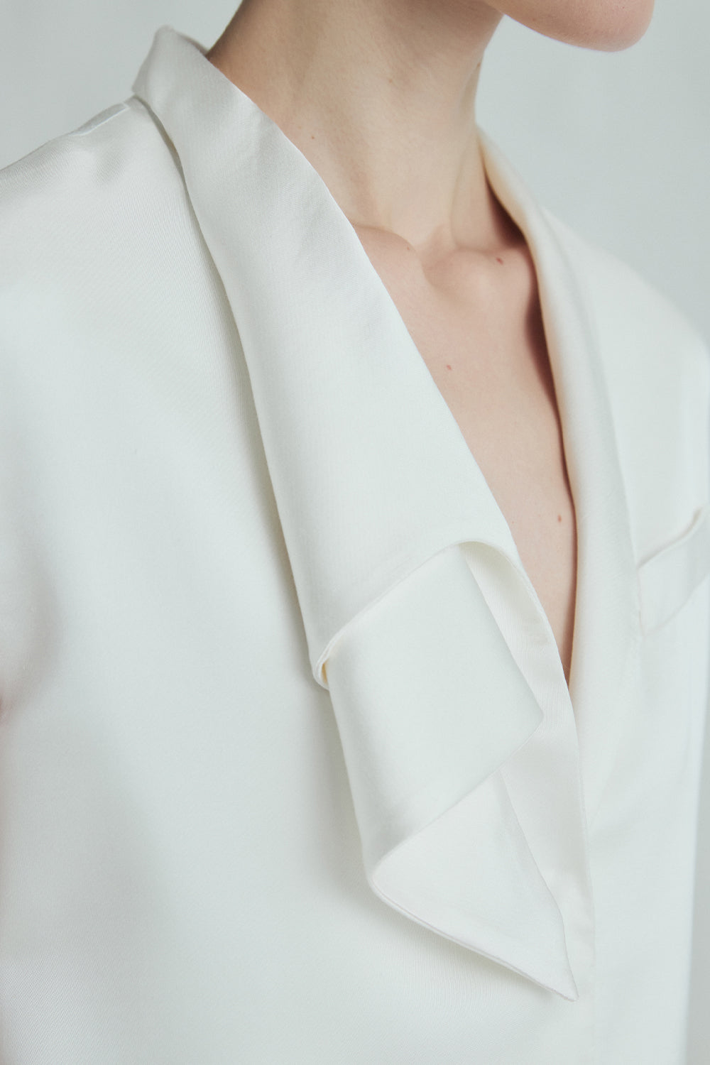 VICKTEERUT Sleeveless Blouse with Sculptural Rolled Neckline เสื้อแขนกุด ปกม้วน